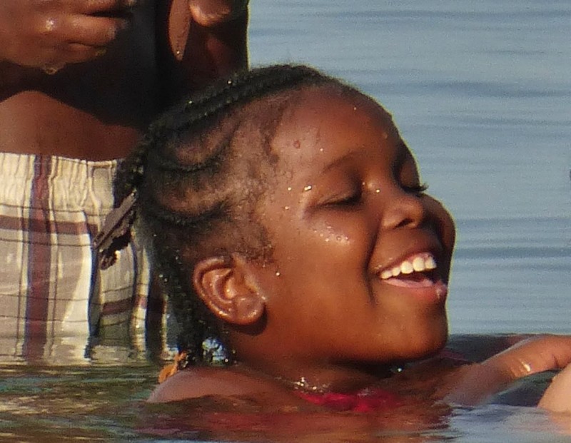 While swimming in the Caribbean Sea in Hopkins, this little girl and her brother swam up and she started braiding Emily’s hair. She didn’t say much but sure was happy playing with blond hair. 